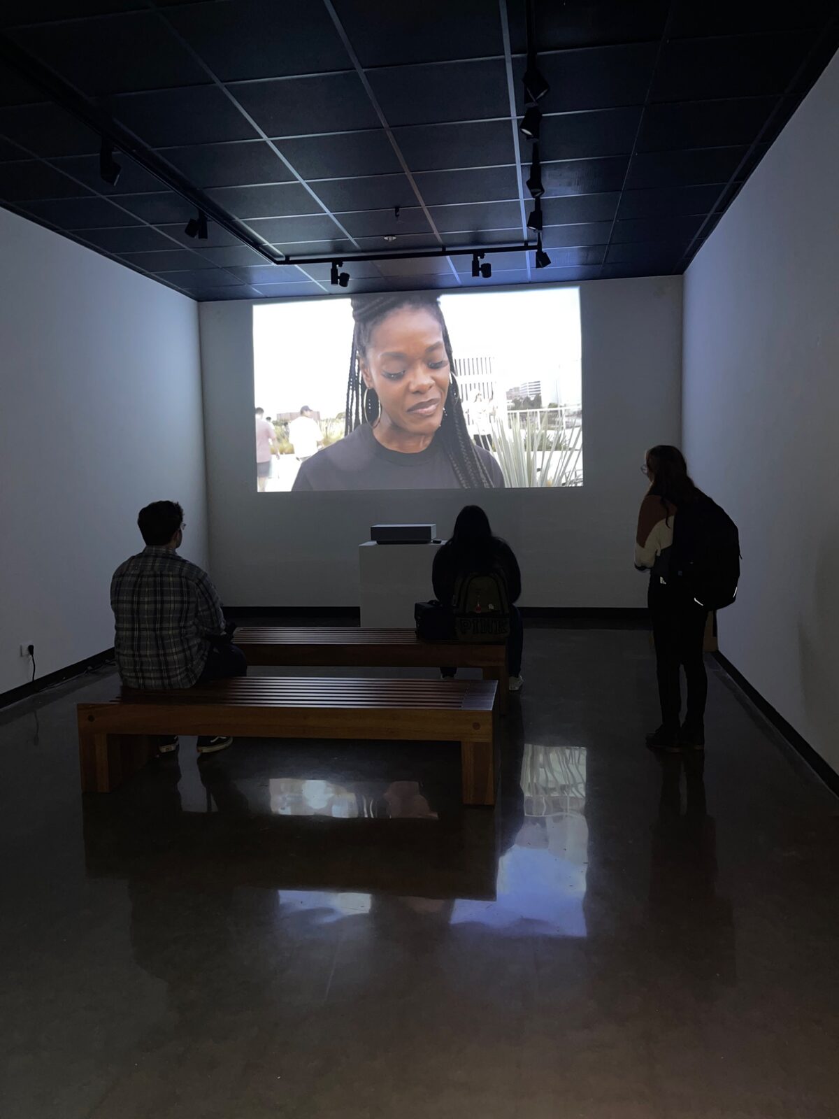 Visitors watching a film in the gallery Black Box