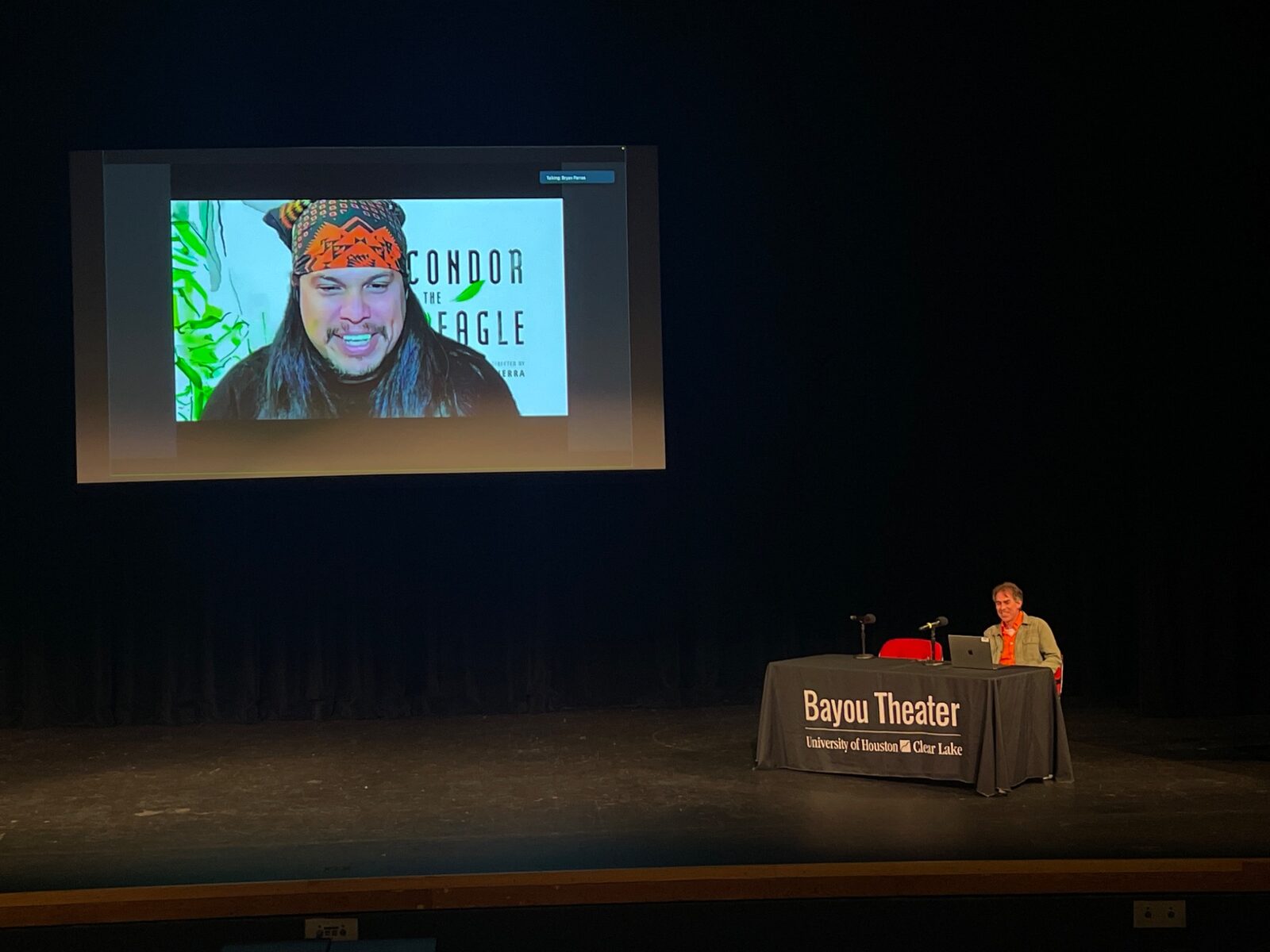 Speaker and remote guest on the Bayou Theater screen