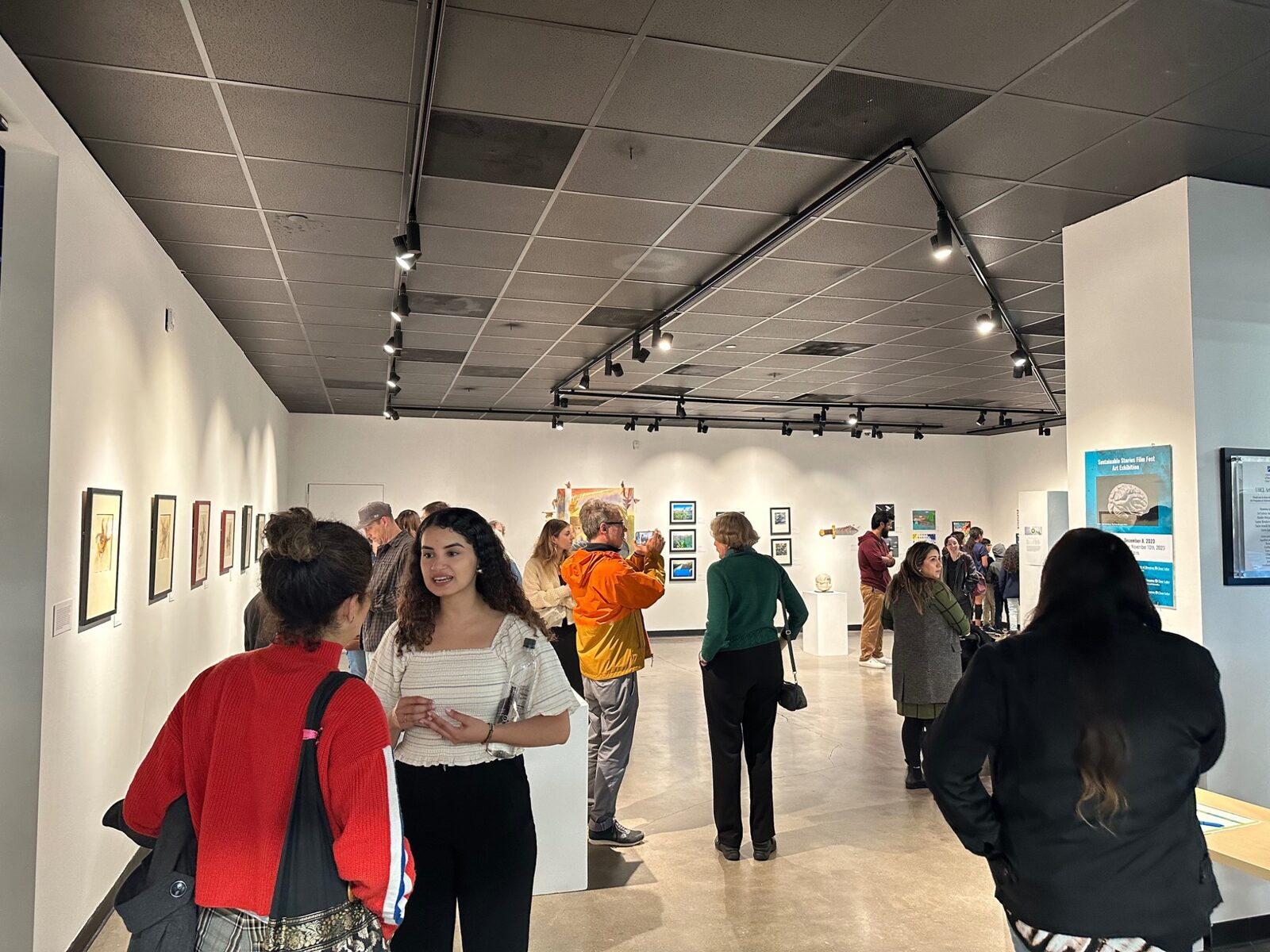 Visitors gathering in the UHCL Art Gallery