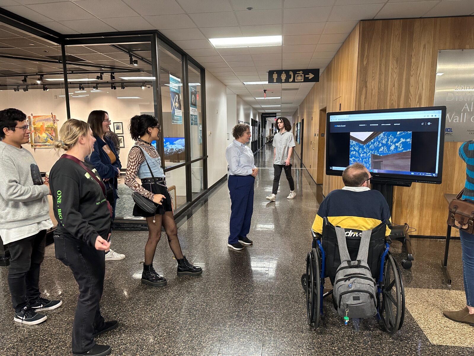 Festival visitors gathered around a digital display