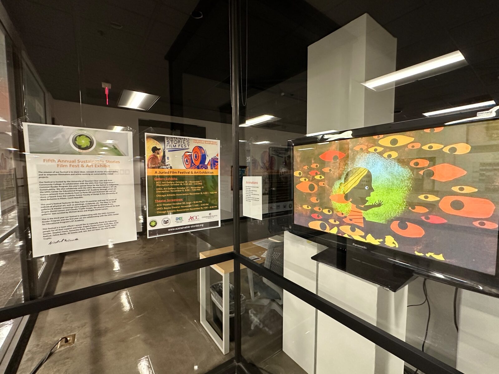 Festival information and animation displayed in a glass exhibition case