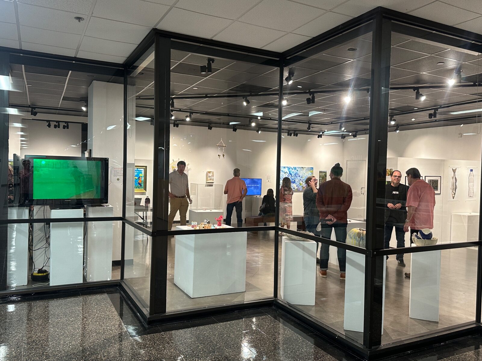 Visitors exploring the UHCL Art Gallery exhibition